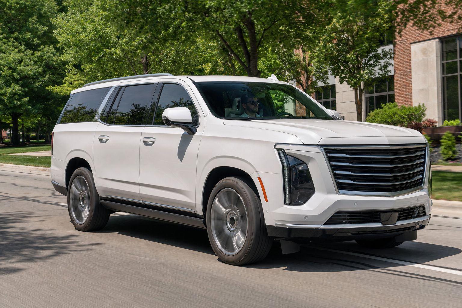 Full-size American luxury SUV with neutral black ceramic film moving through summer daylight.