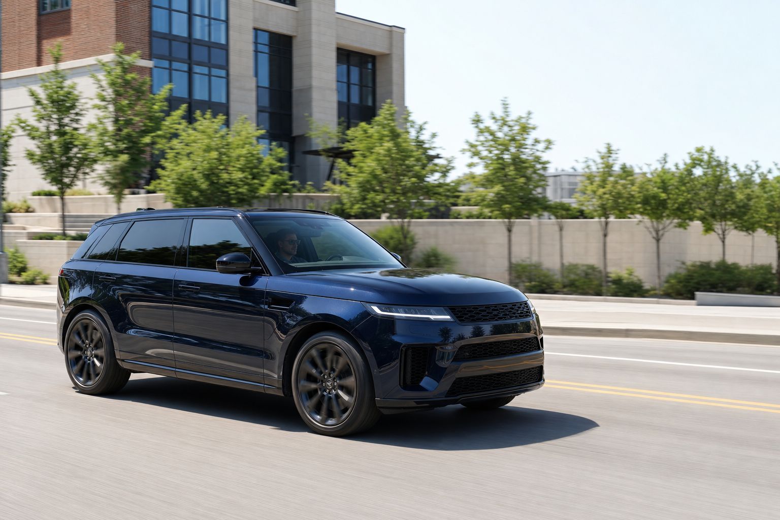 Midnight-navy European luxury SUV with neutral black ceramic film moving through bright summer daylight.