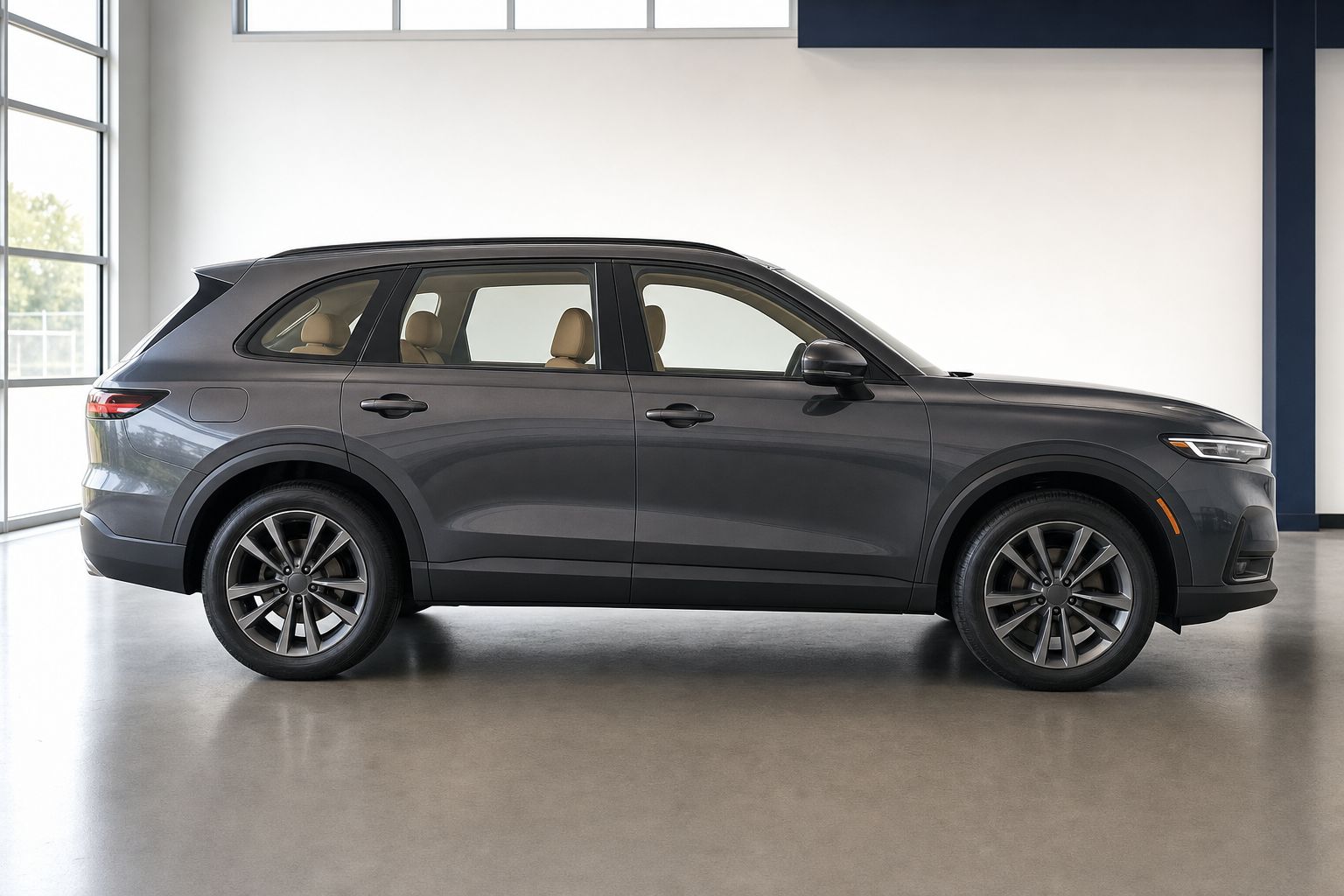 Dark graphite premium SUV with clear side glass and a visible tan interior.